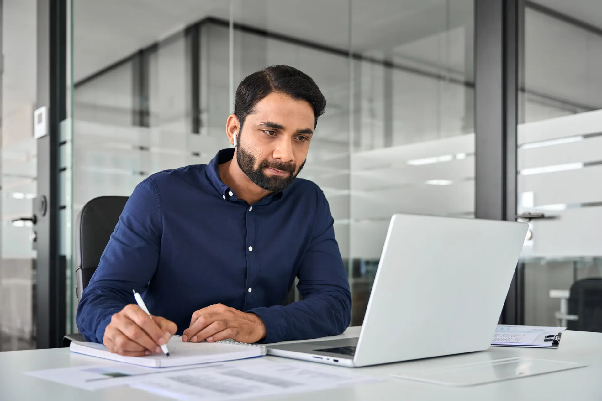 Busy businessman watching elearning webinar using laptop in office.